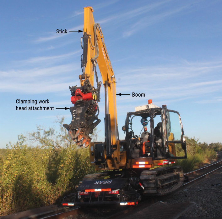 Rail-mounted treaded-tractor with boom attachment