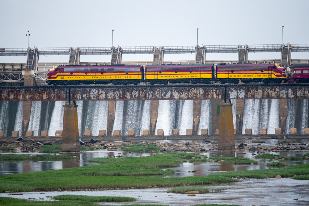 red and yellow loco over dam