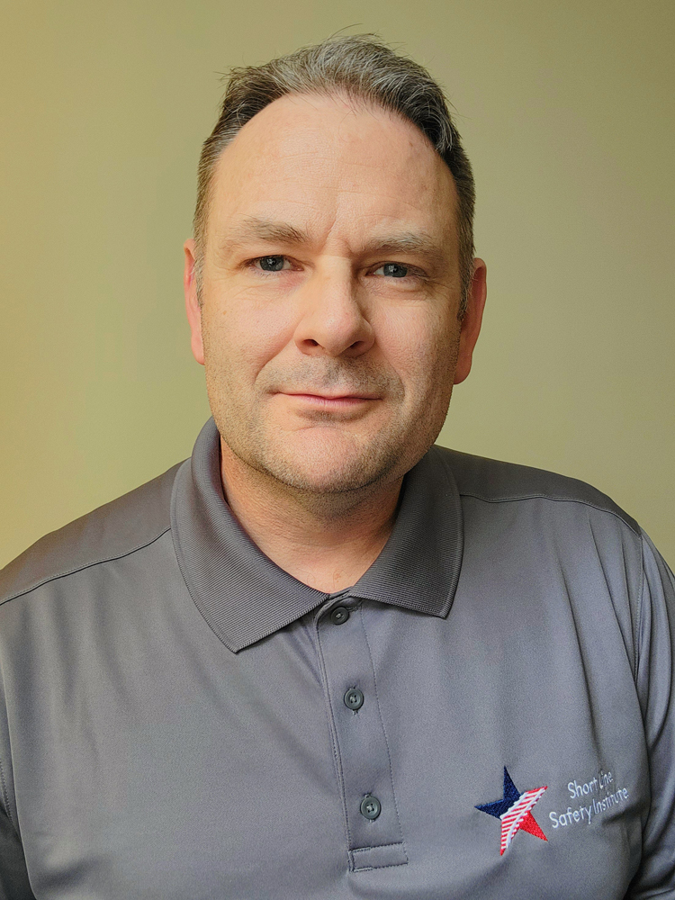 Head shot of man in gray polo shirt