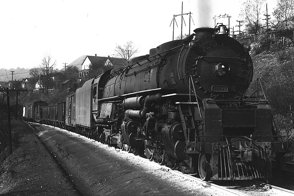 Smoking steam locomotive with freight train