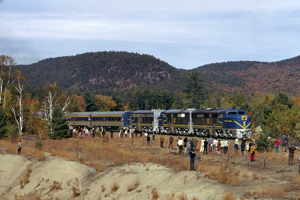 Silver-and-blue diesel Delaware & Hudson locomotives with passenger train surrounded by people
