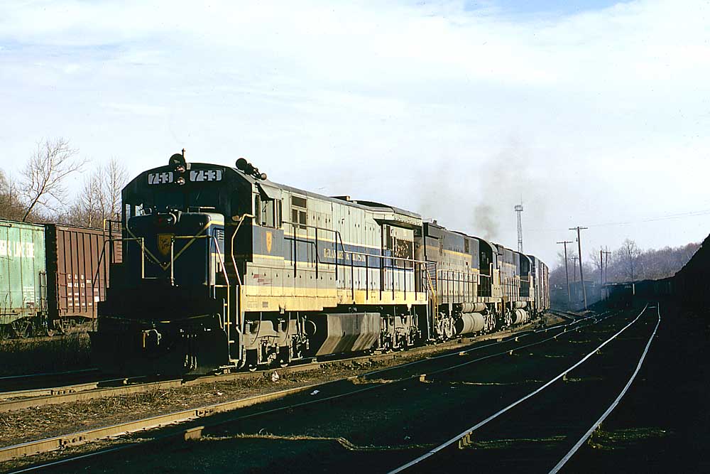 Silver-and-blue diesel Delaware & Hudson locomotives with freight train in yard