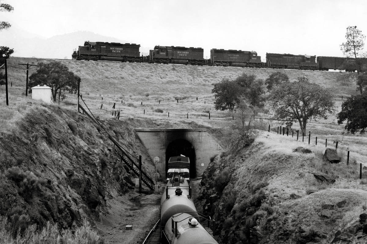 Diesel locomotives with freight train above tunnel