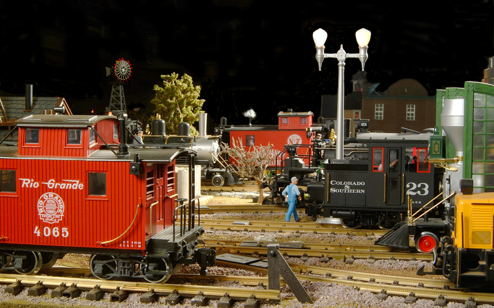 night scene in a model locomotive yard in garden railway