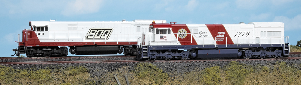 Color photo of two HO scale diesel locomotives on scenic base.