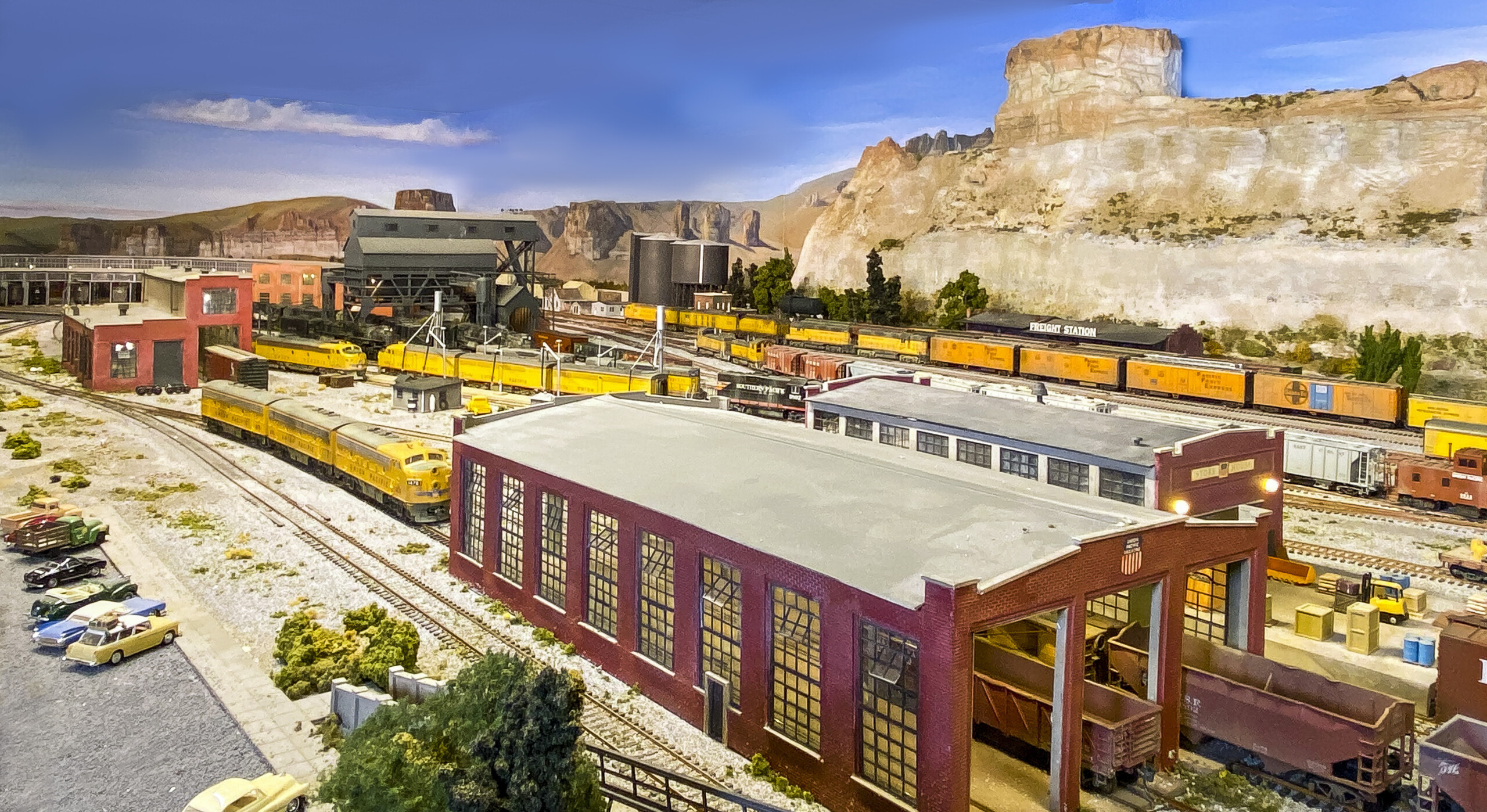 Multiple structures can be seen in the Green River switching yard with trains passing between the stcutures.