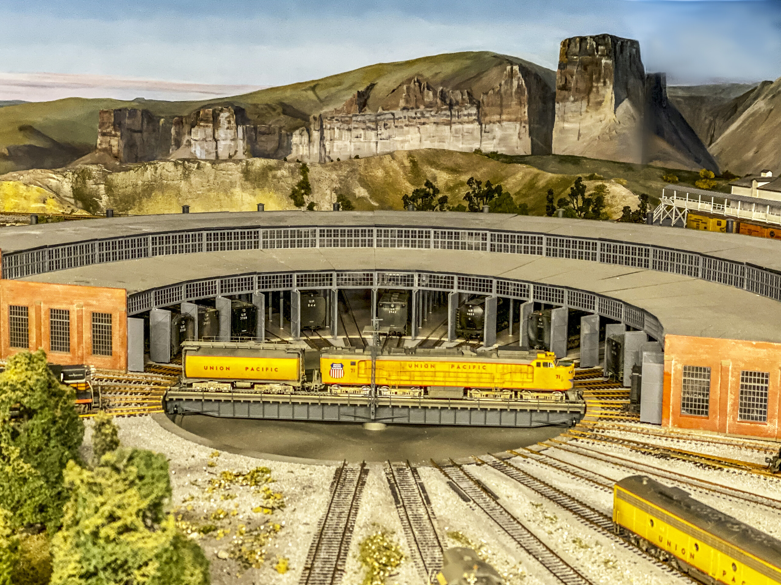 A locomotive is seen on the turntable of the roundhouse