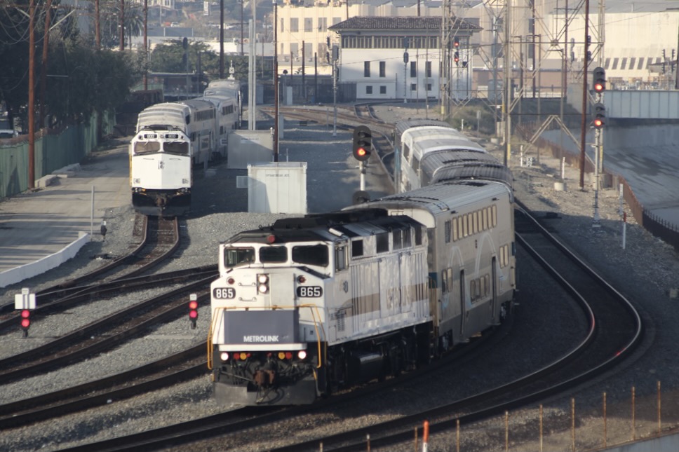 White and blue commuter train rounds curve