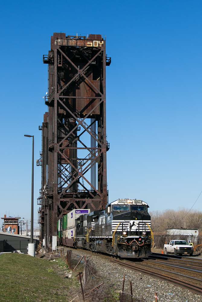 Norfolk Southern train crossing lift bridge. CSX, NS cited for 99 bridge, property violations.