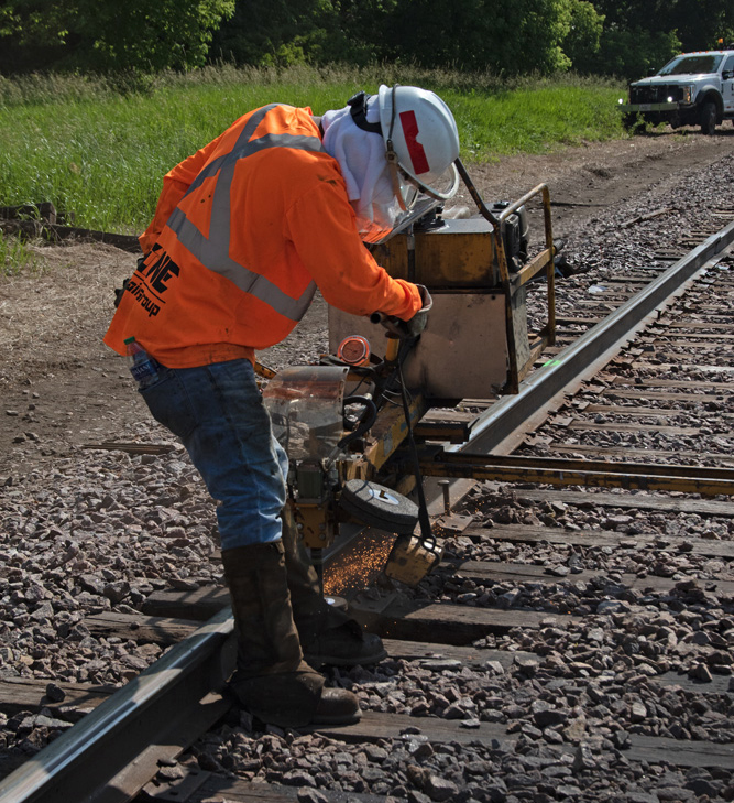 Man with machine working on rail