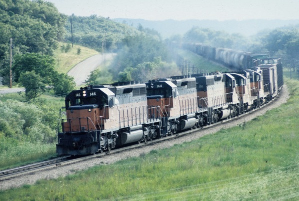 Orange and black diesel locomotives with freight train on curve