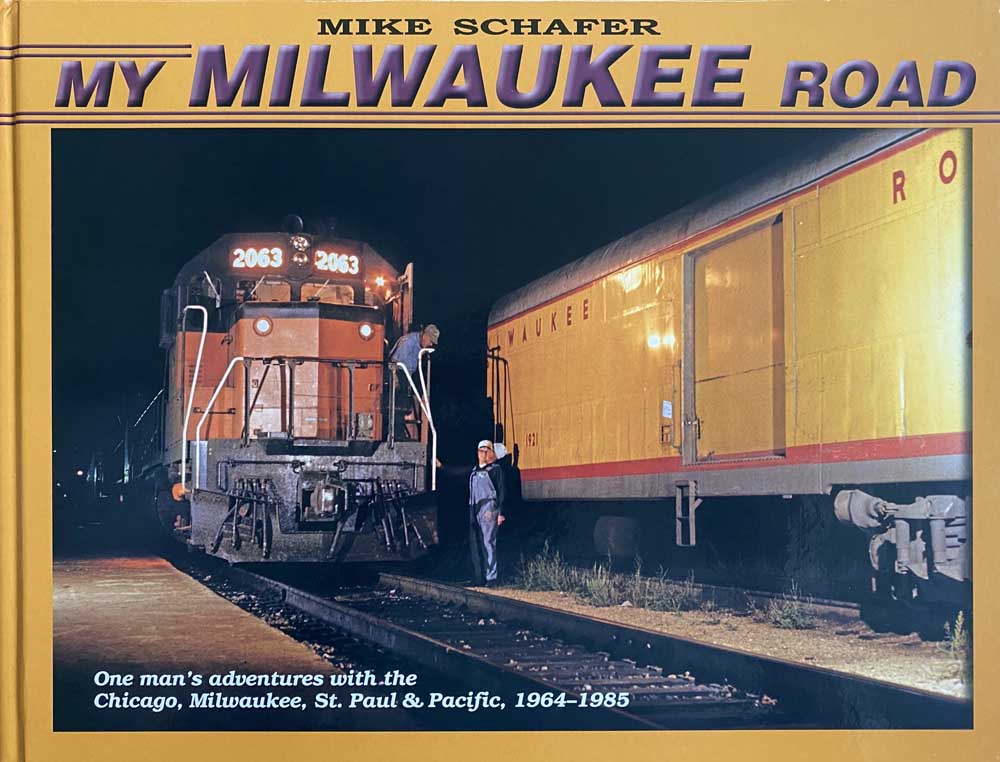 Cover of book with orange diesel locomotive passing yellow passenger train