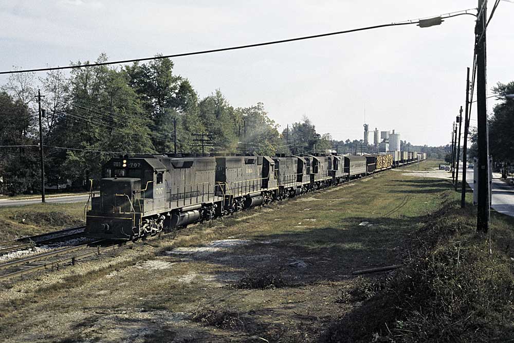 Black diesel locomotives on mixed freight and passenger train