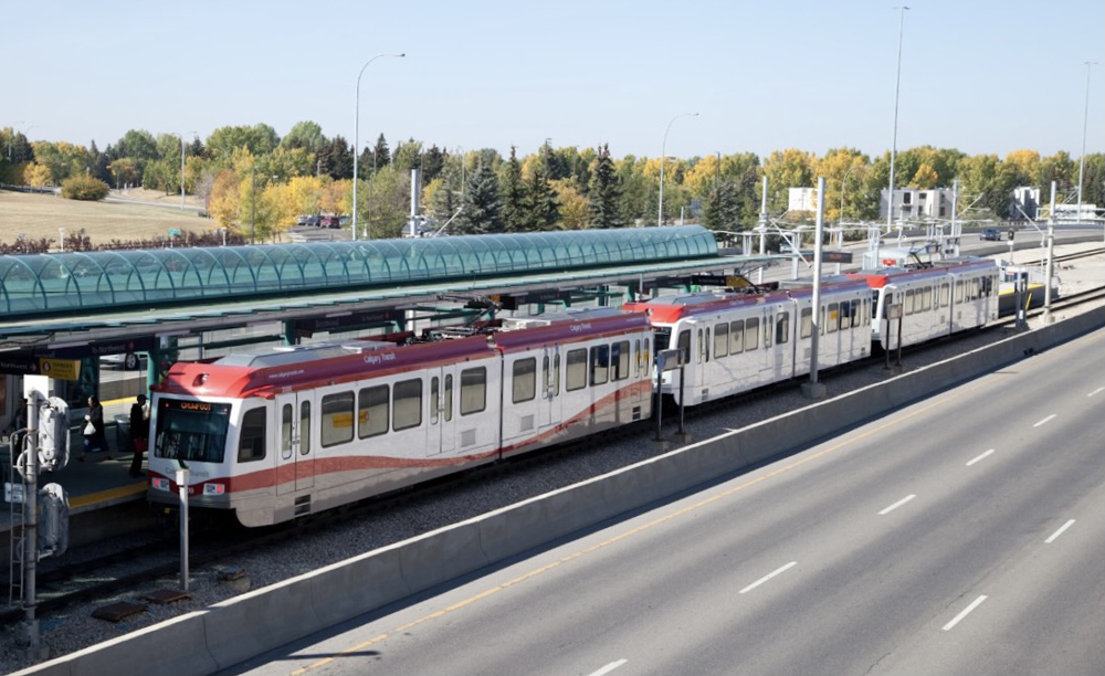 Light rail train at station next to roadway