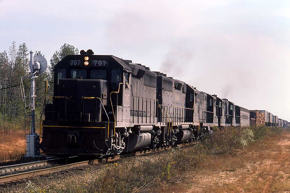 View of Georgia Railroad mixed train with passenger car behind black locomotives