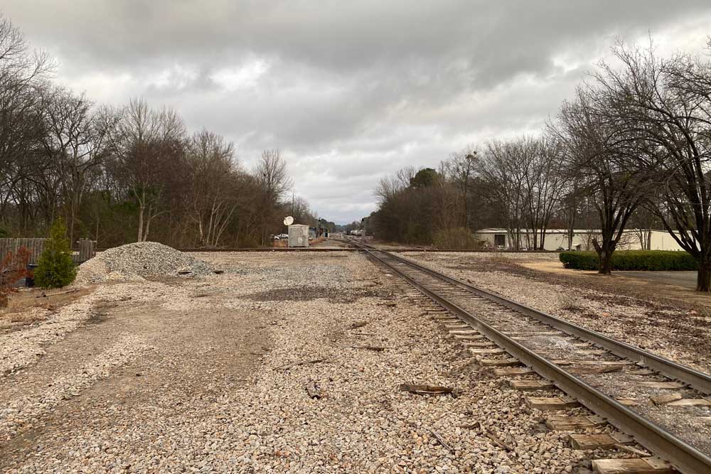 Rail lines crossing in open field