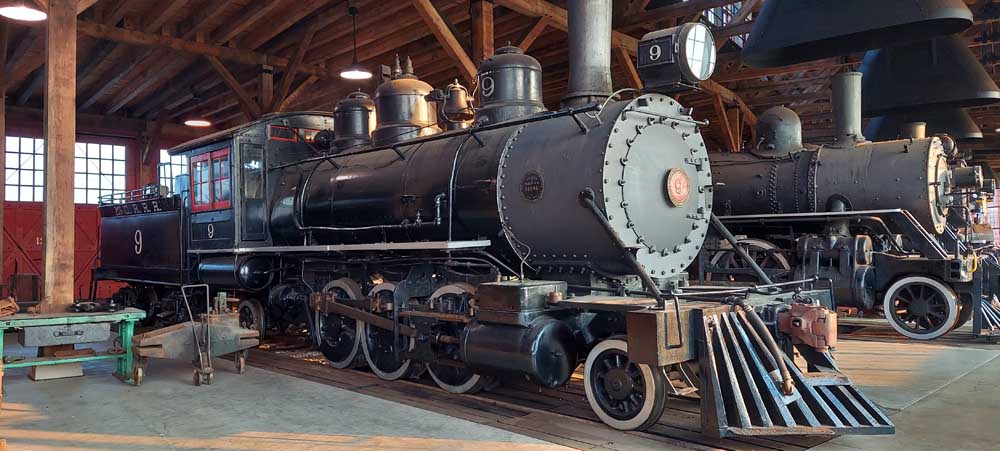 Steam locomotives inside roundhouse