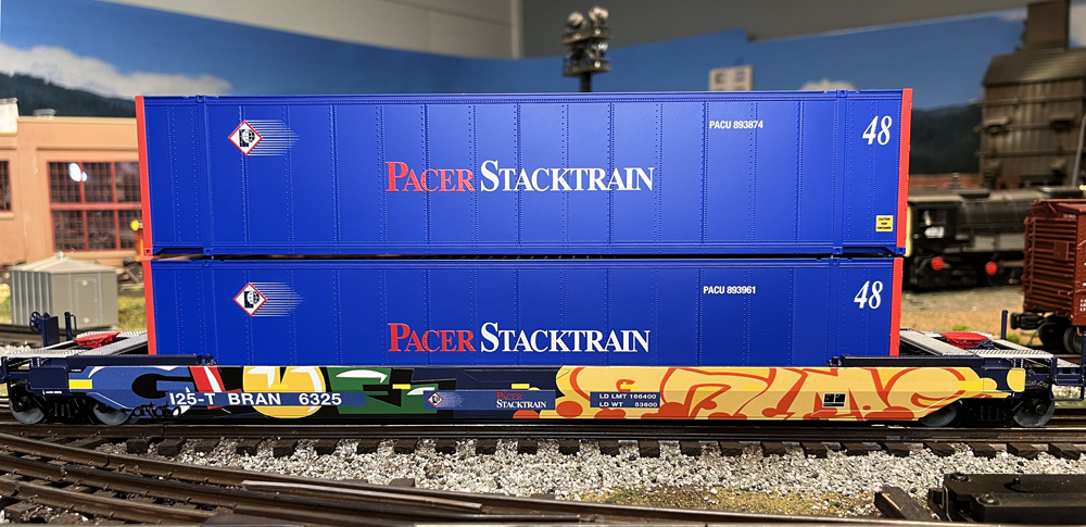 blue stack car with graffiti