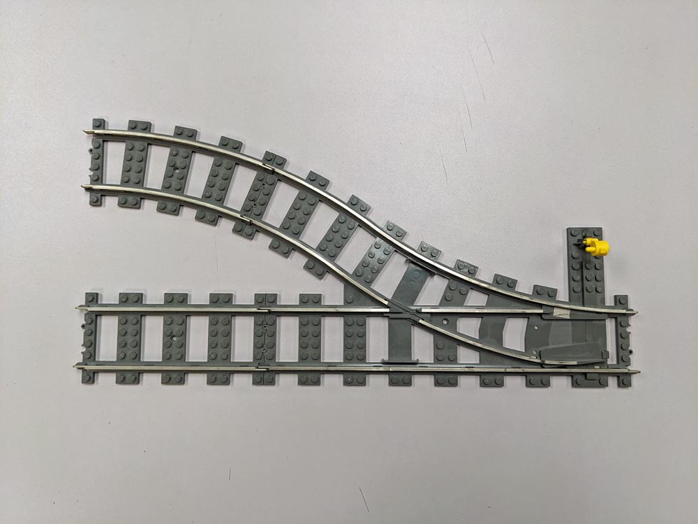 Gray LEGO train track with silver rails on top