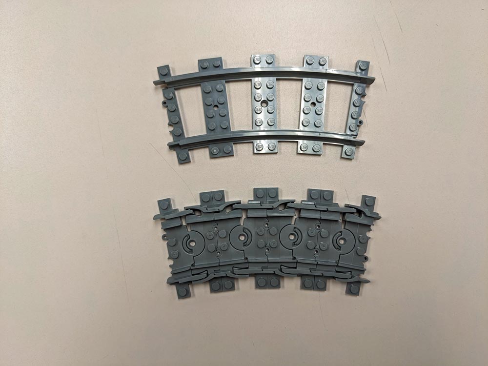 Two pieces of curved LEGO train track