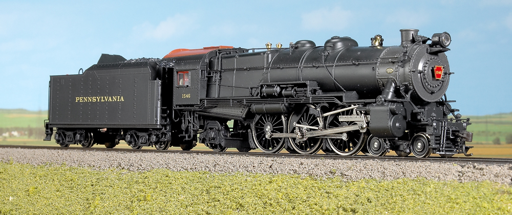 Color photo of HO scale 4-6-2 on scenic base.