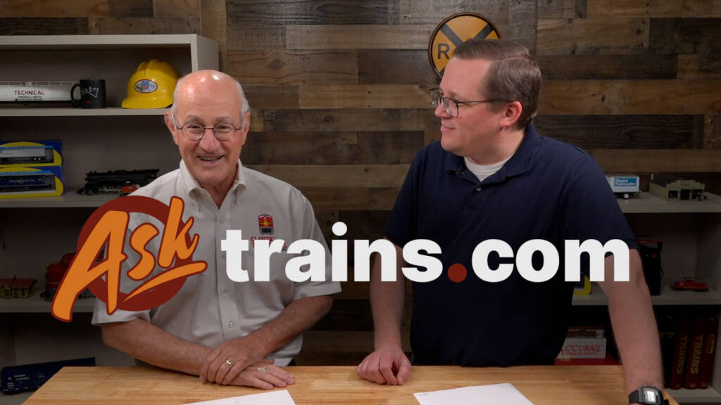 Two men standing behind a table