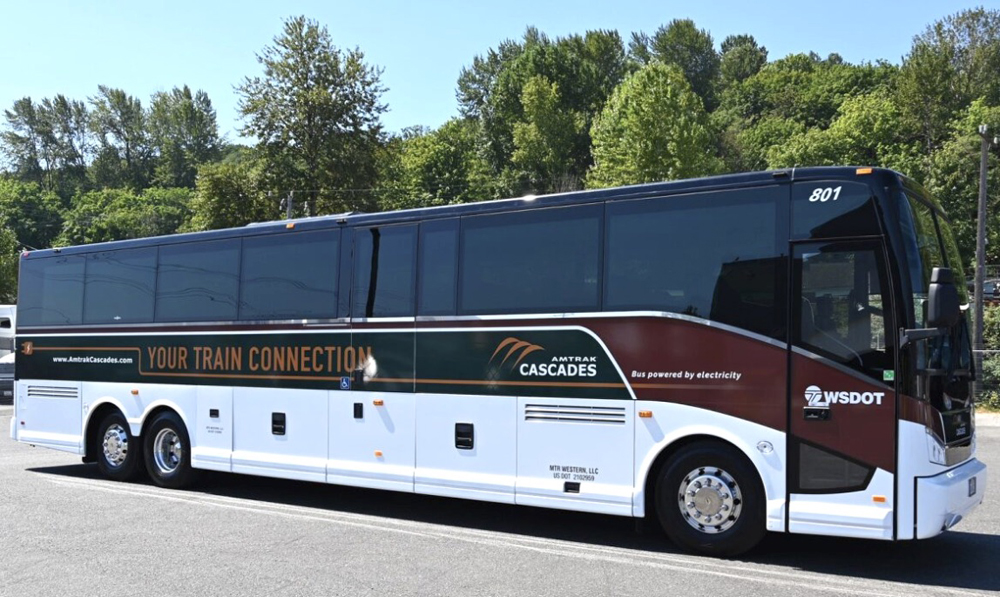 Bus painted in Amtrak Cascade colors of green, brown, and white