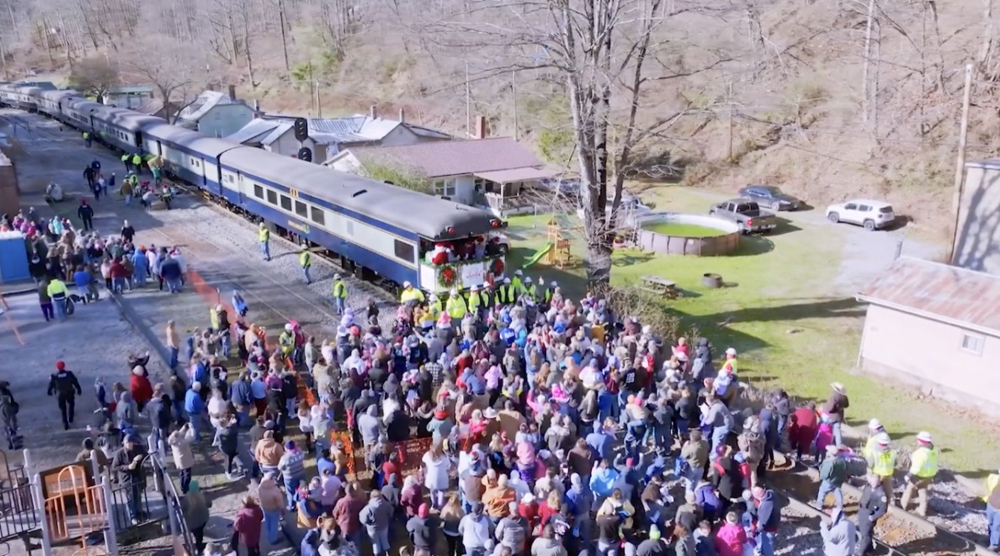 Aerial view of crowd around back of passenger train