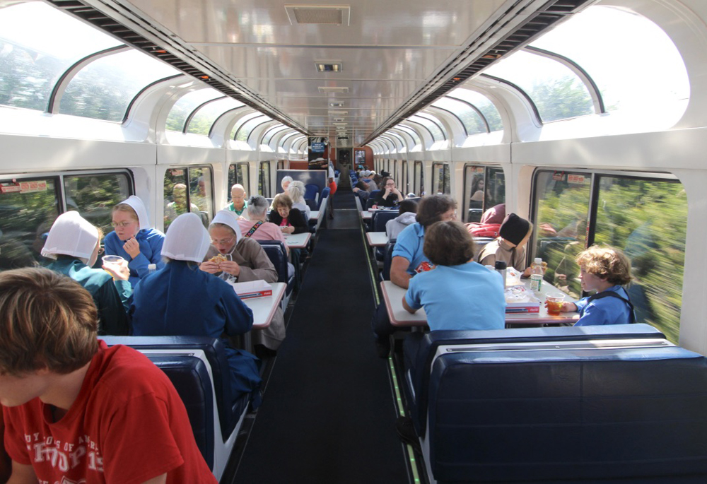Upper level of Amtrak lounge car with almost every seat full