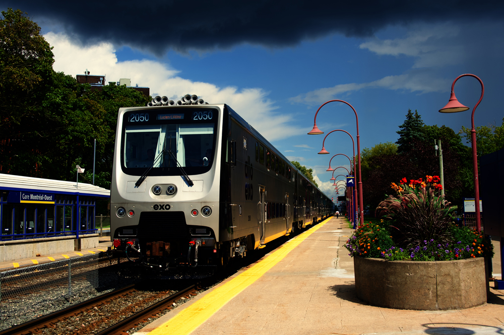 Commuter train with bilevel cab car at station