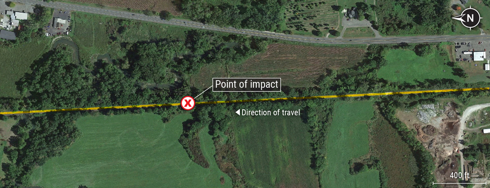 Aerial view of railroad track in rural area with notation showing accident site.