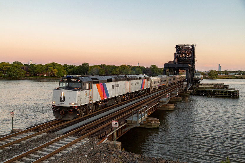 Commuter train with two F40 locomotives crosses bridge