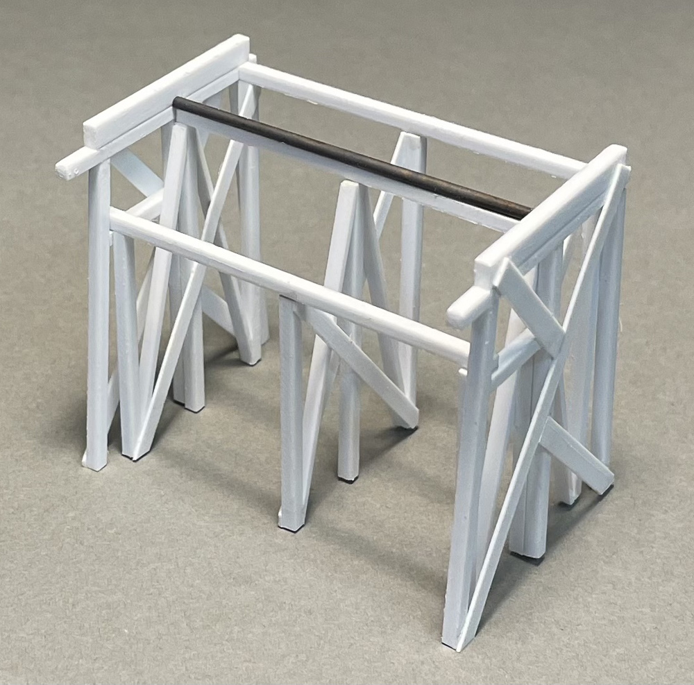 Photo of bent assembly on gray background.