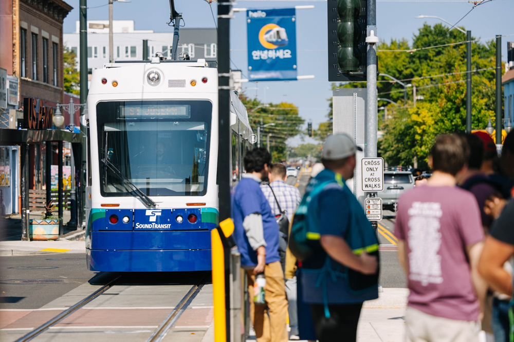 blue and white transit with people standing in front
