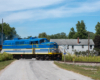 side view of blue, yellow, and gray locomotive