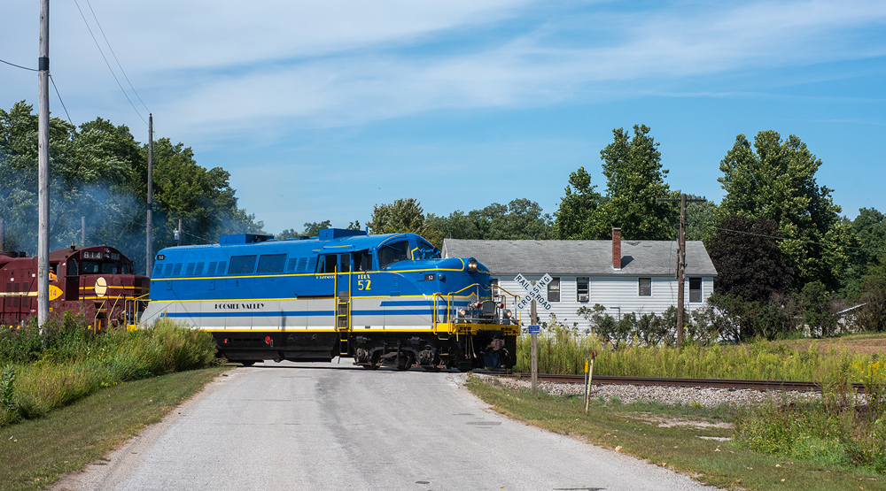 side view of blue, yellow, and gray locomotive