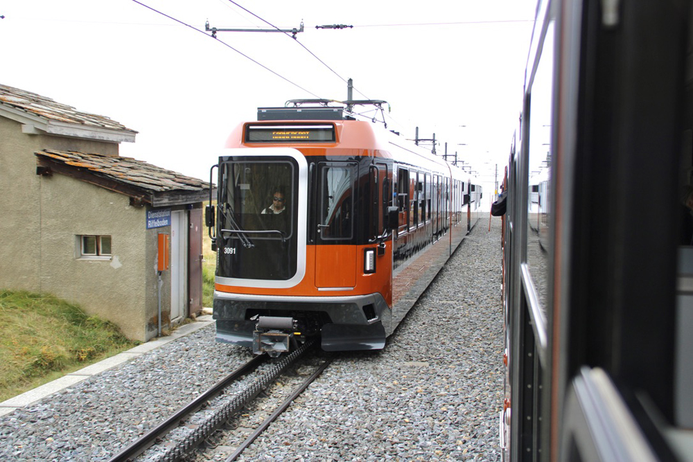 Two cog railway trains meeting.