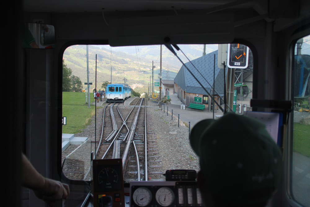 View out front window of train, with another train ahead