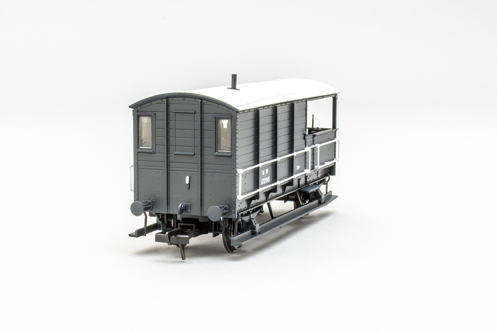 Rear view of a grey and white British train wagon showing two rectangular windows, metal longitudinal wall supports, and a pair of white rectangular handrails along the side of the car.