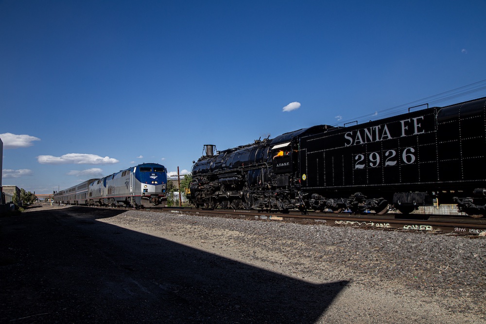 Steam locomotive meets an Amtrak passenger train.