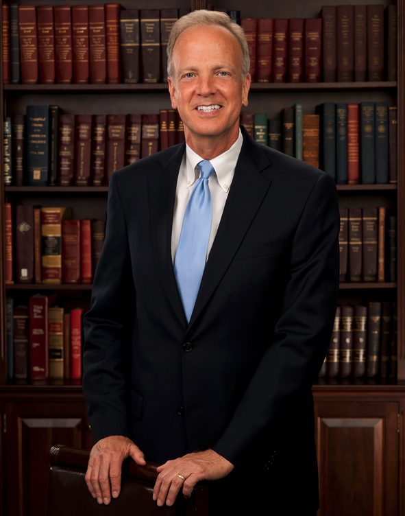 Man in suit standing in library