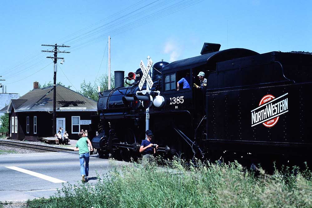 Steam Chicago & North Western locomotives approaching brick station