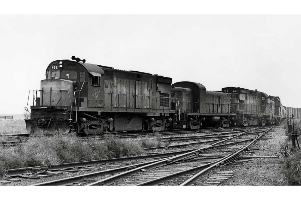 Dirty Chicago & North Western locomotives on freight train