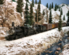 Two steam engines pull a freight alongside a creek and through a rock cut