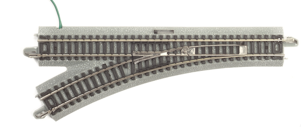 Picture of N scale turnout with gray roadbed on white background