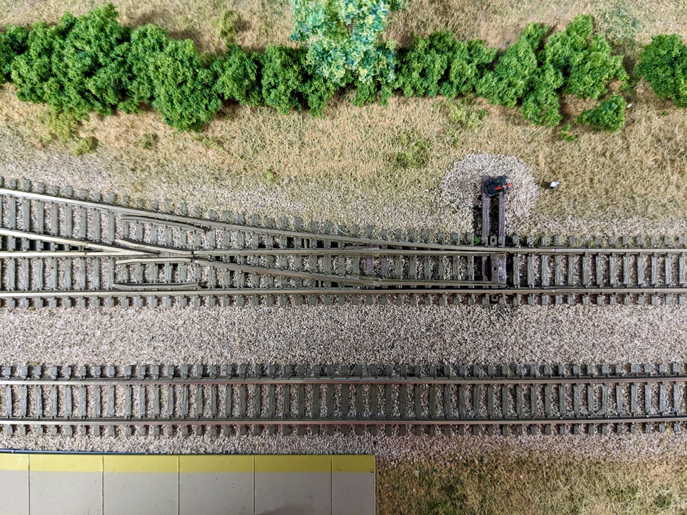 Picture of an N scale turnout in a scenicked area on a layout