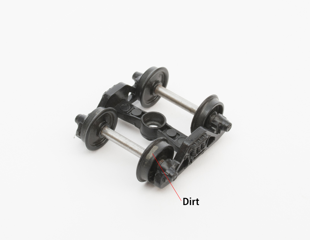 Color photo showing dirt building on wheelset.