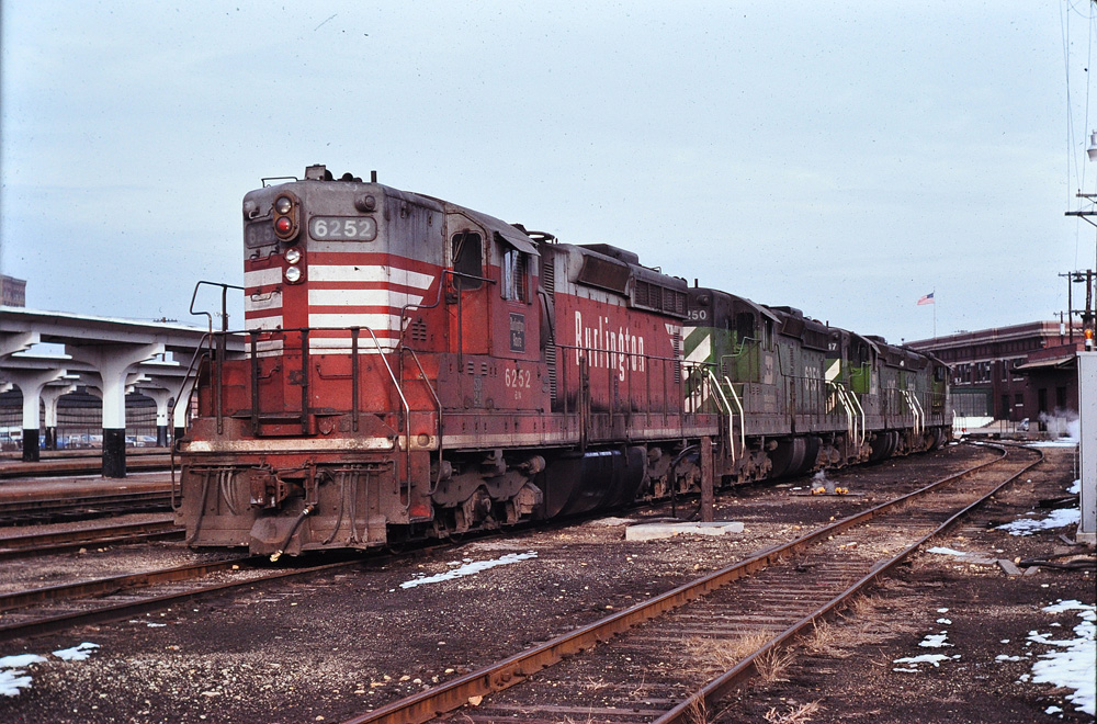 red and white locomotive covered with dirt