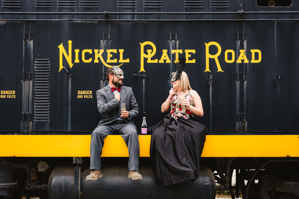 a couple dressed by with black train behind them
