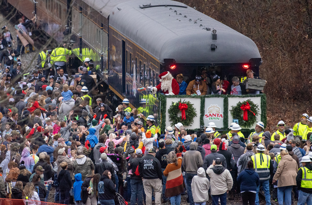 Huge crowd of people around rear platform of passenger train